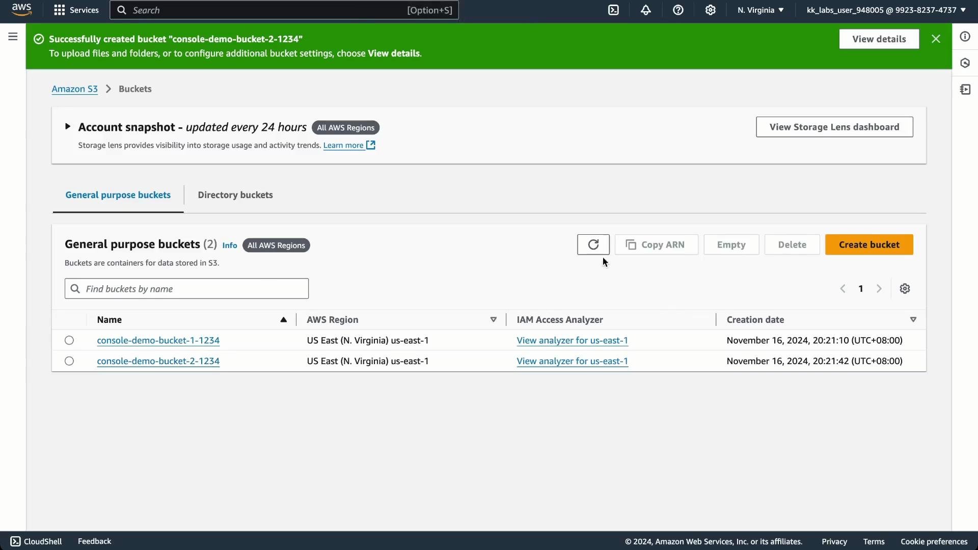 A screenshot of the AWS S3 console showing a green success banner for creating the bucket "console-demo-bucket-2-1234" and the "General purpose buckets" list. The table shows two buckets with their names, AWS region (US East N. Virginia) and creation dates.