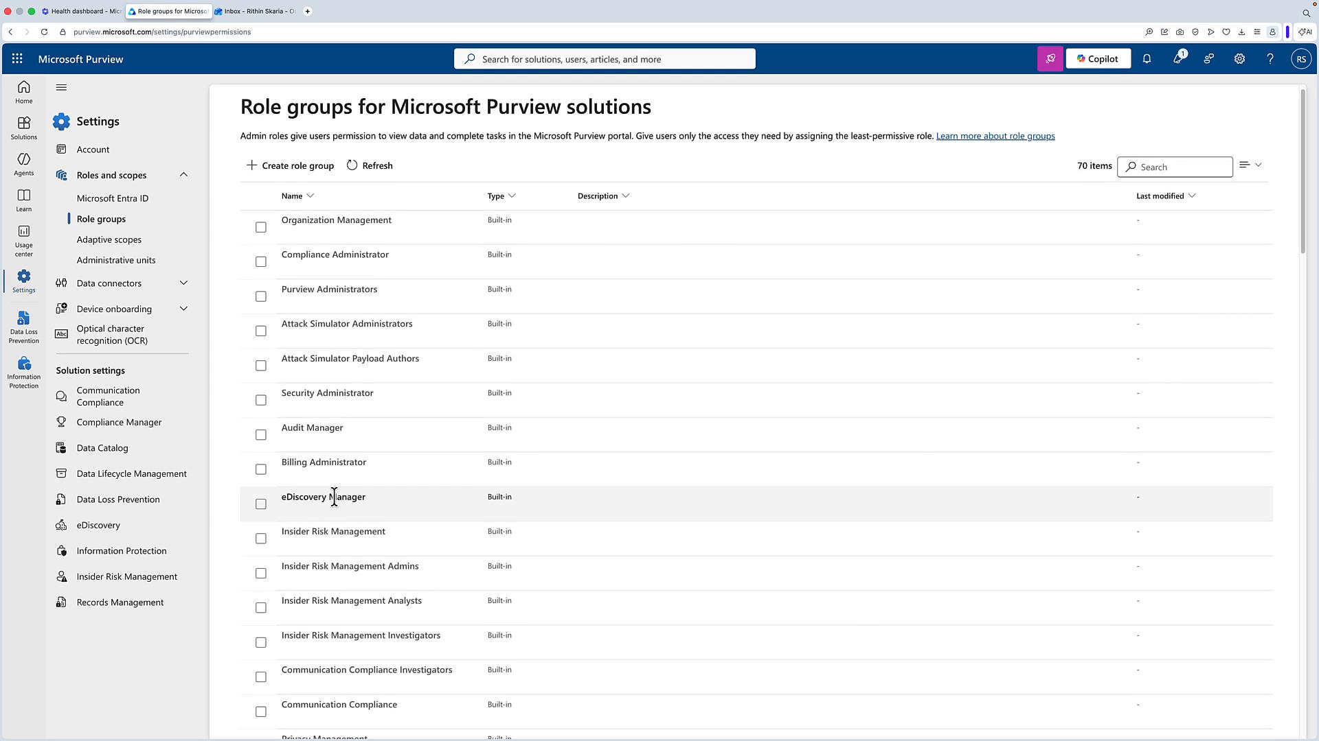 A screenshot of the Microsoft Purview admin portal displaying the "Role groups for Microsoft Purview solutions" page with a list of built-in role groups (e.g., Organization Management, Compliance Administrator, eDiscovery Manager). The left sidebar shows navigation for Settings, Roles and scopes, Data connectors, and other solution settings.