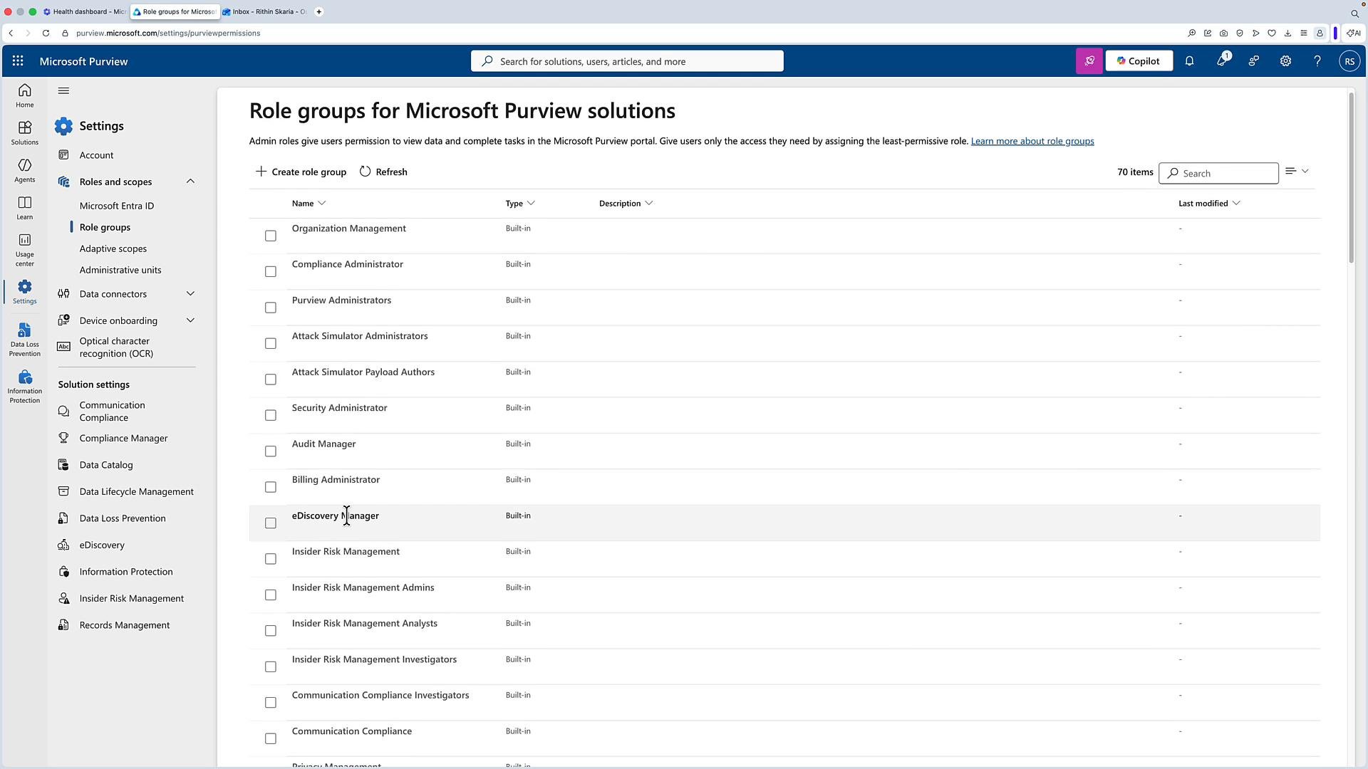 A screenshot of the Microsoft Purview admin portal displaying the "Role groups for Microsoft Purview solutions" page with a list of built-in role groups (e.g., Organization Management, Compliance Administrator, eDiscovery Manager). The left sidebar shows navigation for Settings, Roles and scopes, Data connectors, and other solution settings.