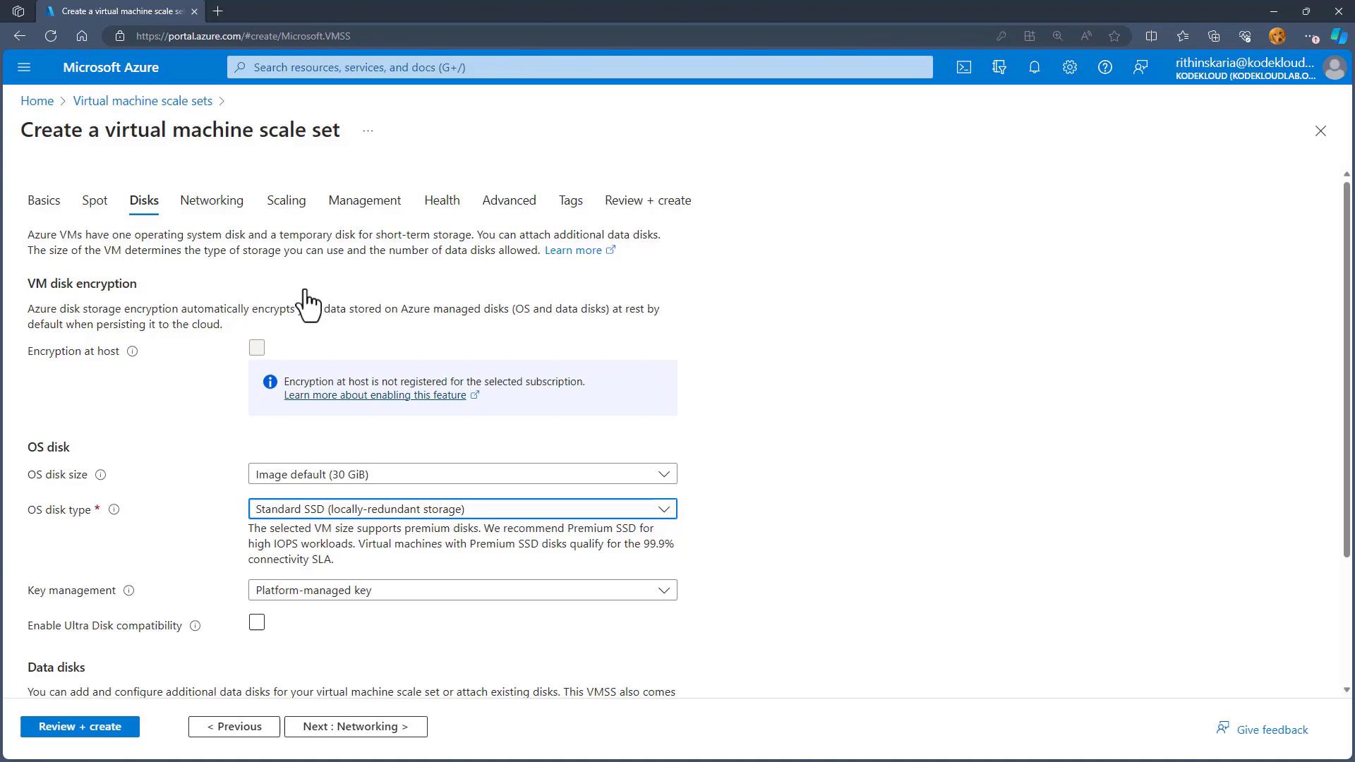 A screenshot of the Microsoft Azure portal on the "Create a virtual machine scale set" page, open to the "Disks" tab. The UI shows VM disk encryption, OS disk size/type, key management, and navigation buttons (Review + create, Previous, Next).