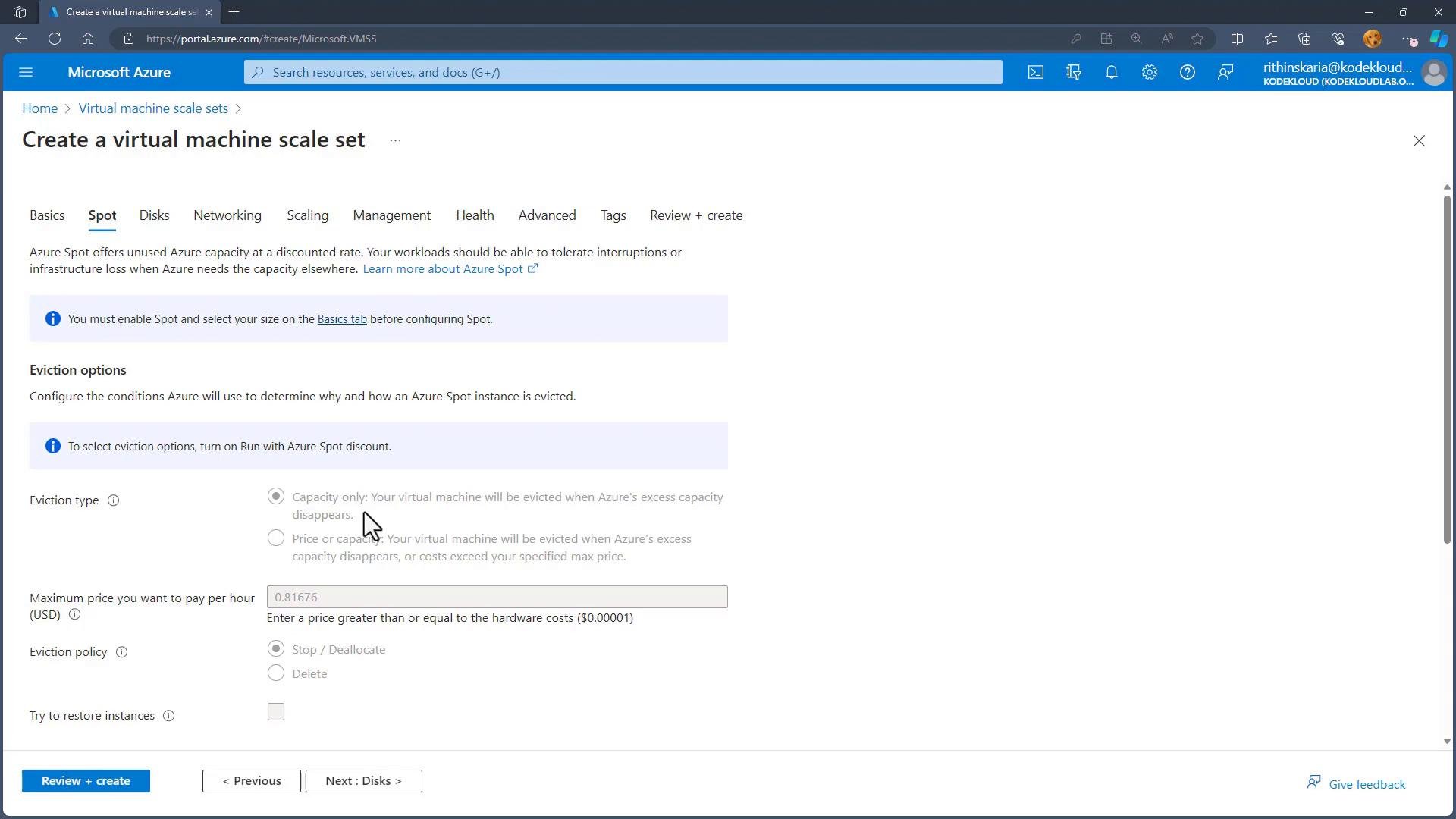 A screenshot of the Microsoft Azure portal on the "Create a virtual machine scale set" page, open to the "Spot" tab showing Spot/eviction options like eviction type, maximum price per hour, and eviction policy. Navigation buttons ("Review + create", "< Previous", "Next: Disks >") and the Azure header are visible.