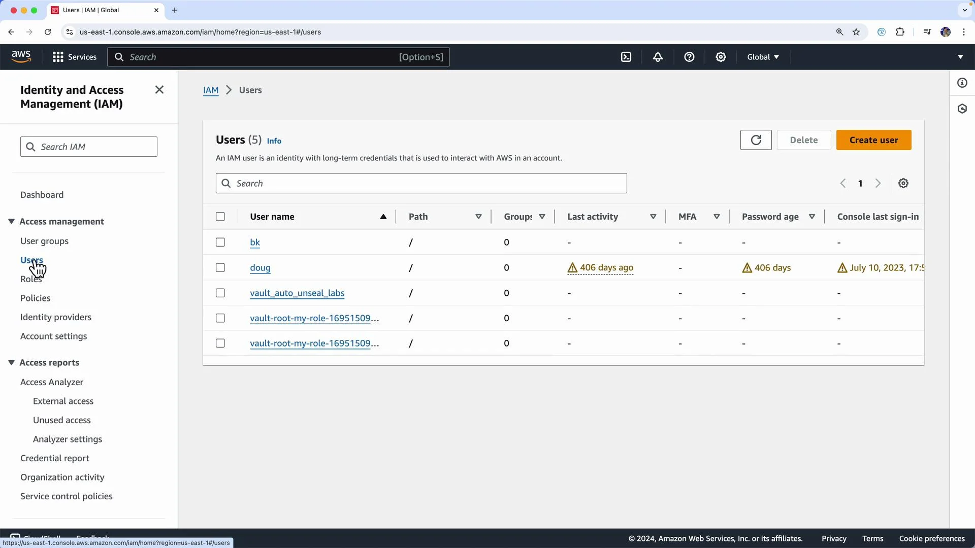 The image shows an AWS Identity and Access Management (IAM) user interface with a list of users and details like last activity, password age, and console last sign-in times. There are navigation options for managing groups, roles, policies, and access reports on the left side.