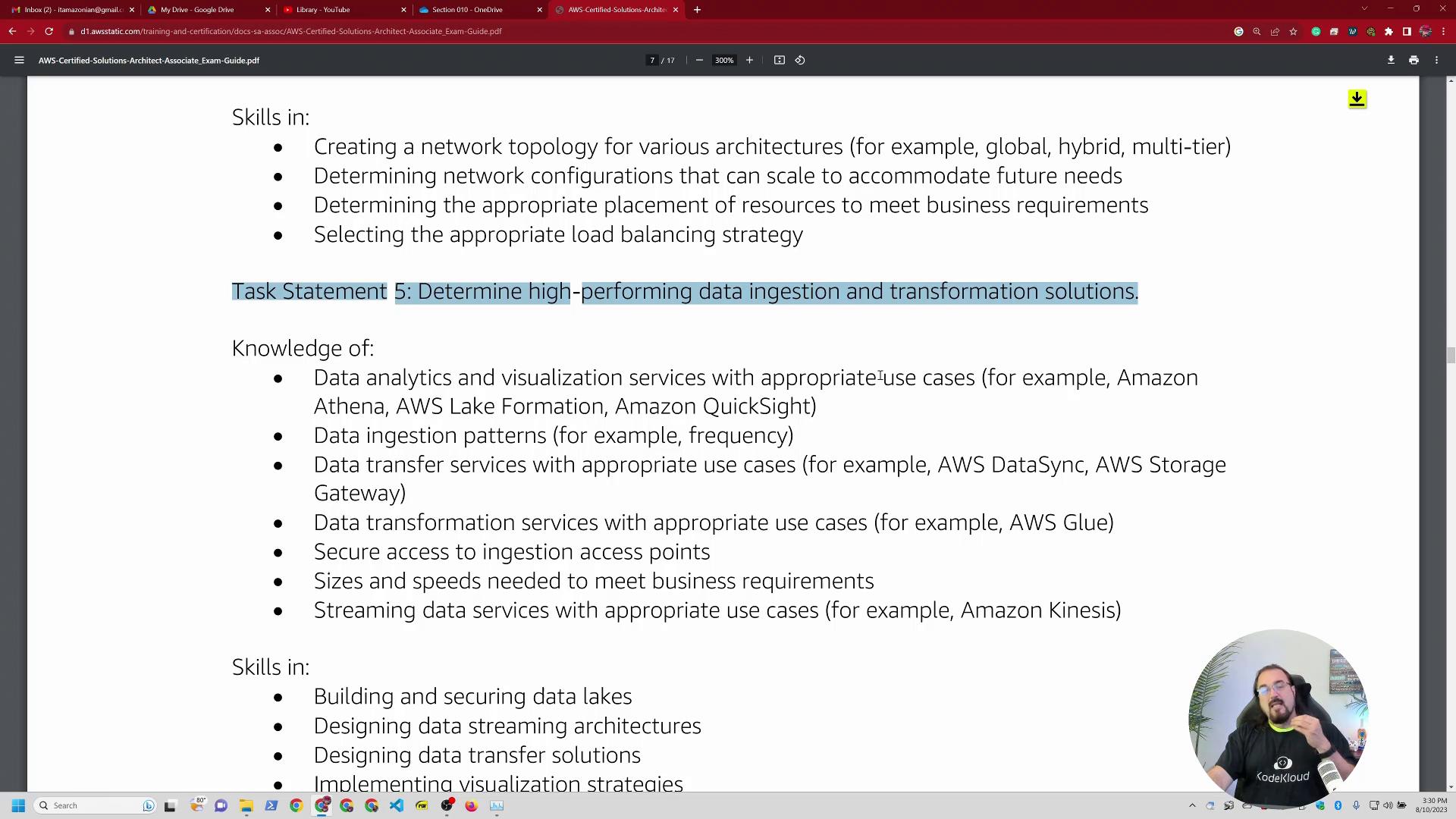 A screenshot of a PDF page listing AWS skills and knowledge, with a highlighted line that reads "Task Statement 5: Determine high-performing data ingestion and transformation solutions." A circular webcam overlay of a man speaking appears at the bottom-right, and browser tabs/toolbars are visible along the top.