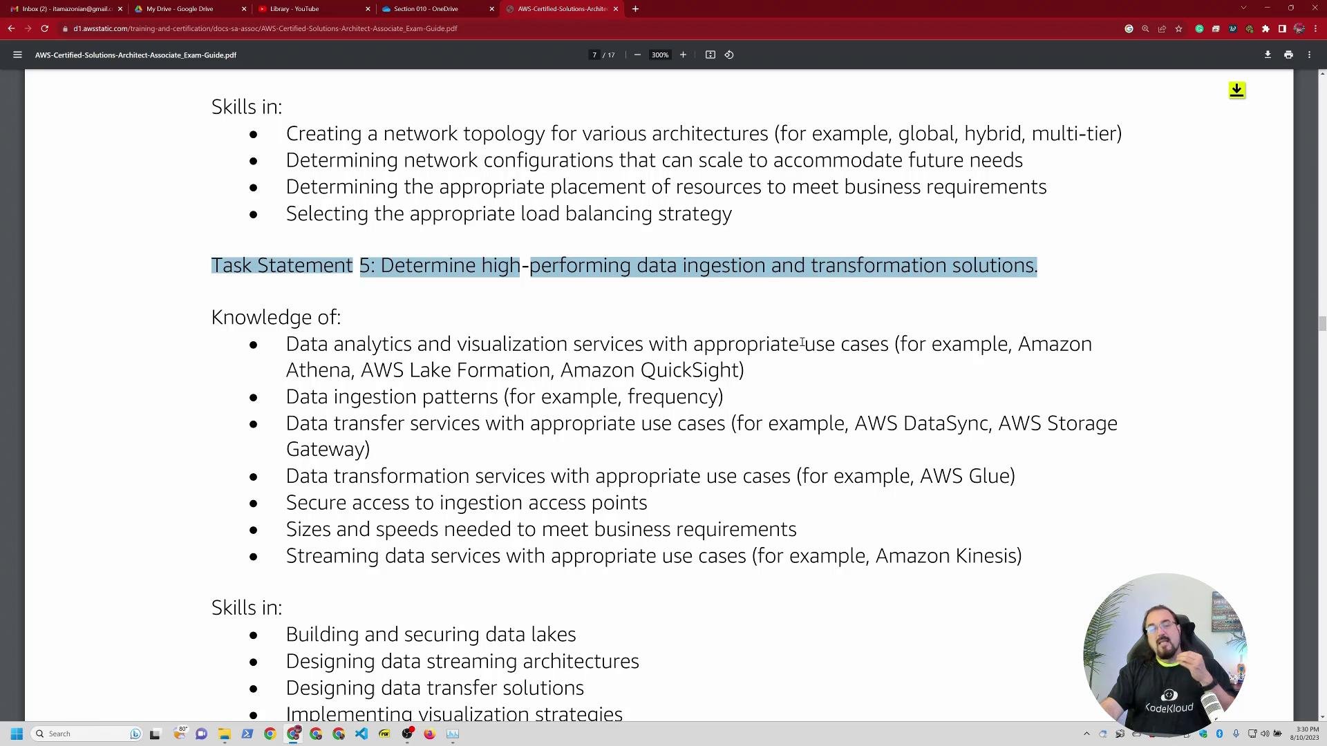 A screenshot of a PDF page listing AWS skills and knowledge, with a highlighted line that reads "Task Statement 5: Determine high-performing data ingestion and transformation solutions." A circular webcam overlay of a man speaking appears at the bottom-right, and browser tabs/toolbars are visible along the top.