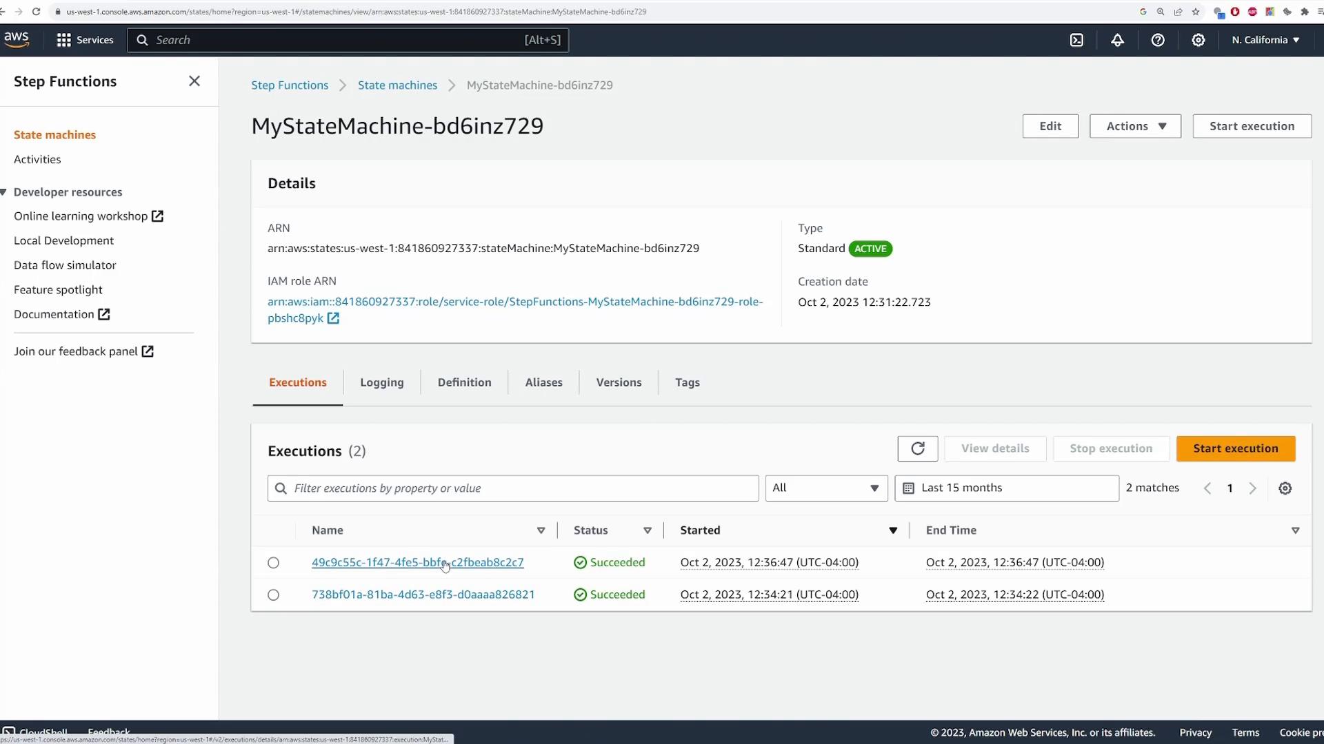 A screenshot of the AWS Step Functions console showing a state machine named "MyStateMachine-bd6inz729" with its details, ARN, and status (Standard, Active). The lower panel lists recent executions (two succeeded) and buttons for editing or starting an execution.