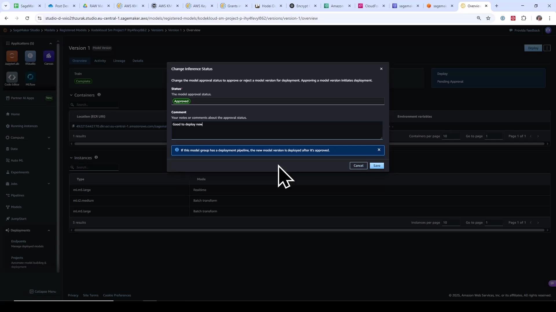 A screenshot of AWS SageMaker Studio showing a "Change Inference Status" dialog with the model status set to "Approved" and the comment "Good to deploy now." A large mouse cursor is hovering over the Save button.