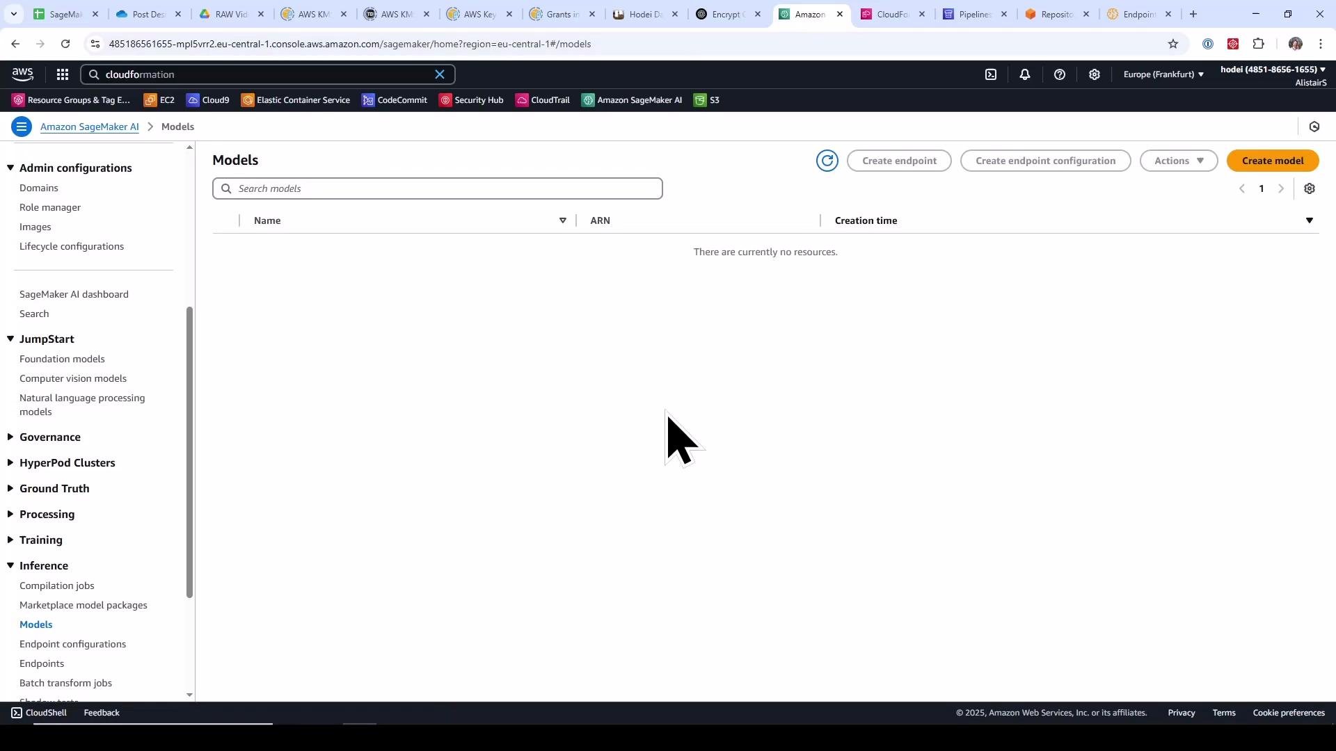 A screenshot of the Amazon SageMaker "Models" page in the AWS console showing an empty models list. The left navigation menu (Admin configurations, JumpStart, Inference, etc.) and browser tabs are visible, with a large mouse cursor near the center.