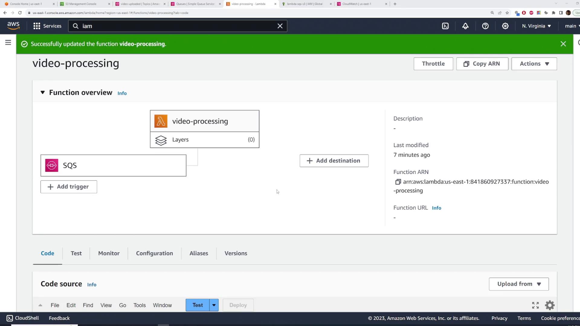 A screenshot of the AWS Lambda console showing a function named "video-processing" with an SQS trigger and a green banner indicating the function was successfully updated. The page displays function details (ARN, last modified) and tabs for Code, Test, Monitor, Configuration, etc.