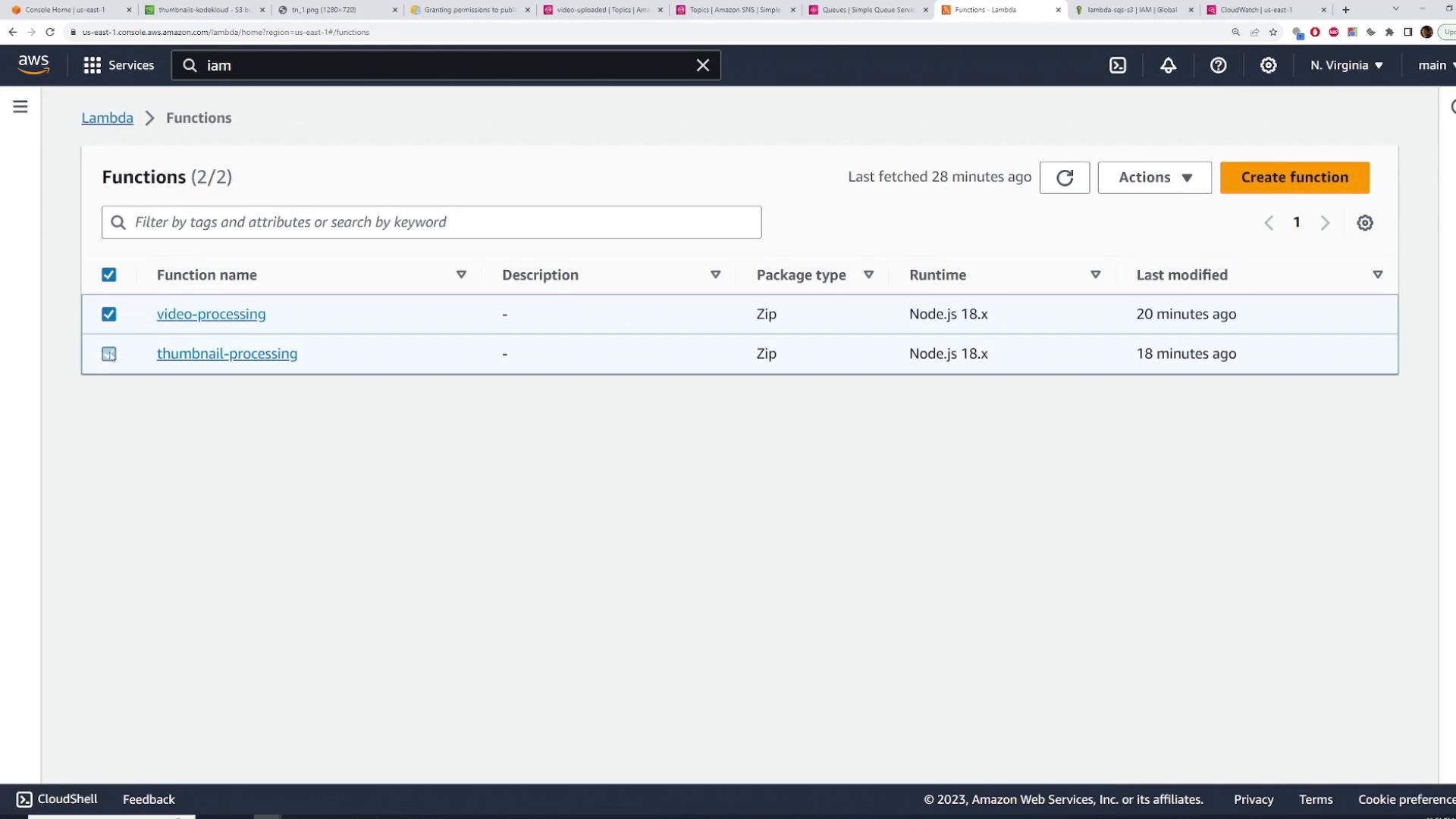 Screenshot of the AWS Lambda Functions page showing two functions: "video-processing" and "thumbnail-processing." Both are Zip package type running Node.js 18.x and were last modified about 20 and 18 minutes ago.