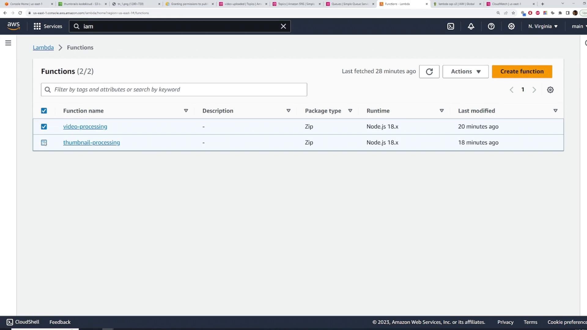 Screenshot of the AWS Lambda Functions page showing two functions: "video-processing" and "thumbnail-processing." Both are Zip package type running Node.js 18.x and were last modified about 20 and 18 minutes ago.