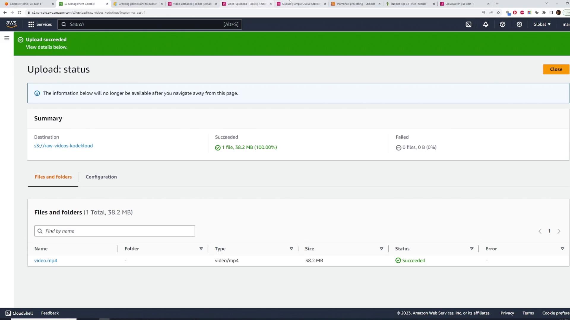 Screenshot of the AWS S3 console showing an "Upload succeeded" status for one file (video.mp4, 38.2 MB) uploaded to the bucket s3://raw-videos-kodekloud. The summary shows 1 file succeeded and 0 failed.