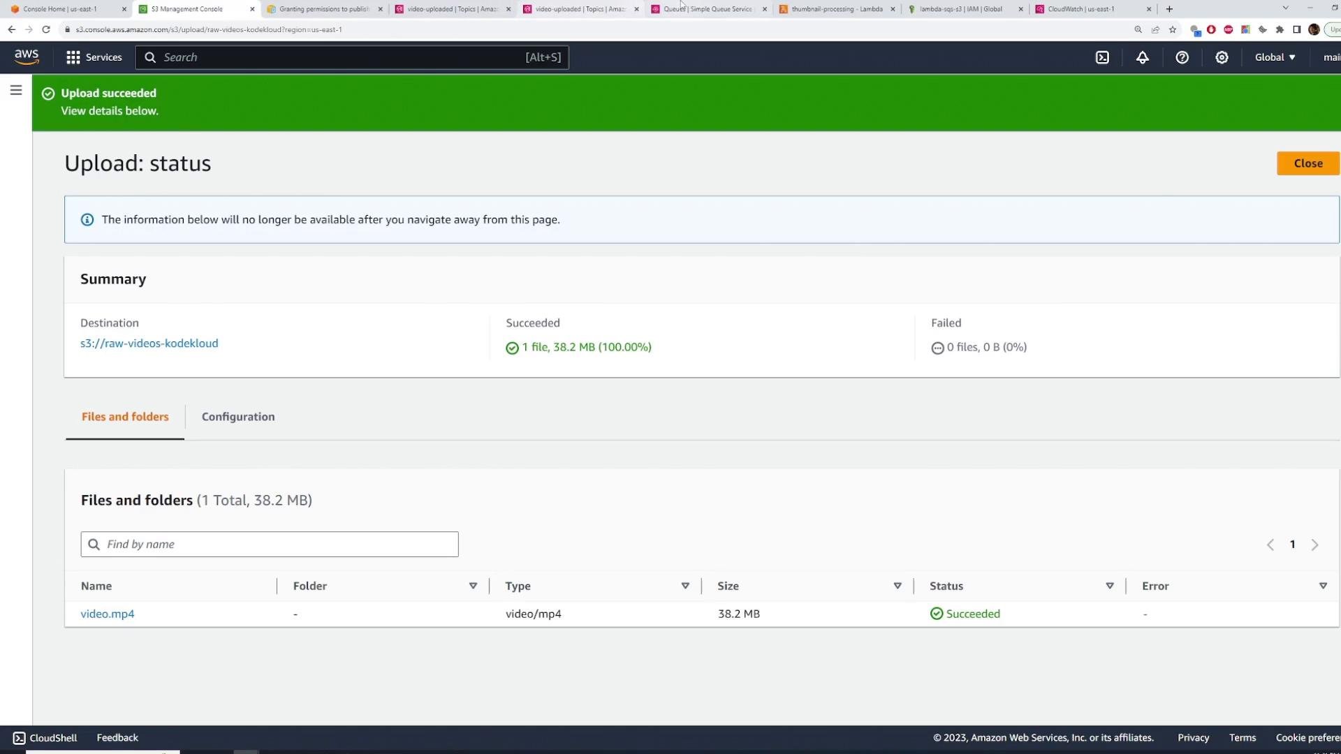 Screenshot of the AWS S3 console showing an "Upload succeeded" status for one file (video.mp4, 38.2 MB) uploaded to the bucket s3://raw-videos-kodekloud. The summary shows 1 file succeeded and 0 failed.