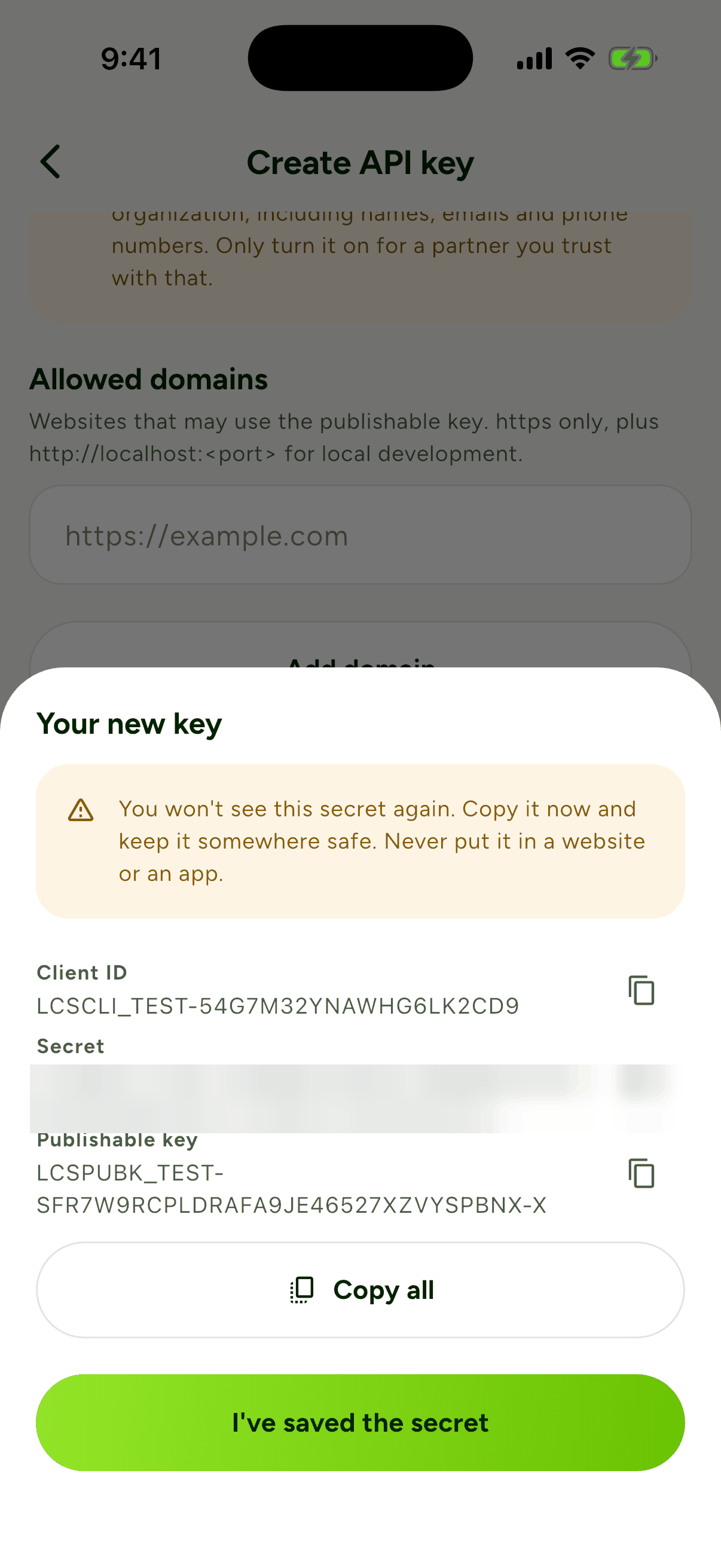 The Your new key sheet showing the client ID, a blurred secret and the publishable key, with Copy all and I've saved the secret buttons