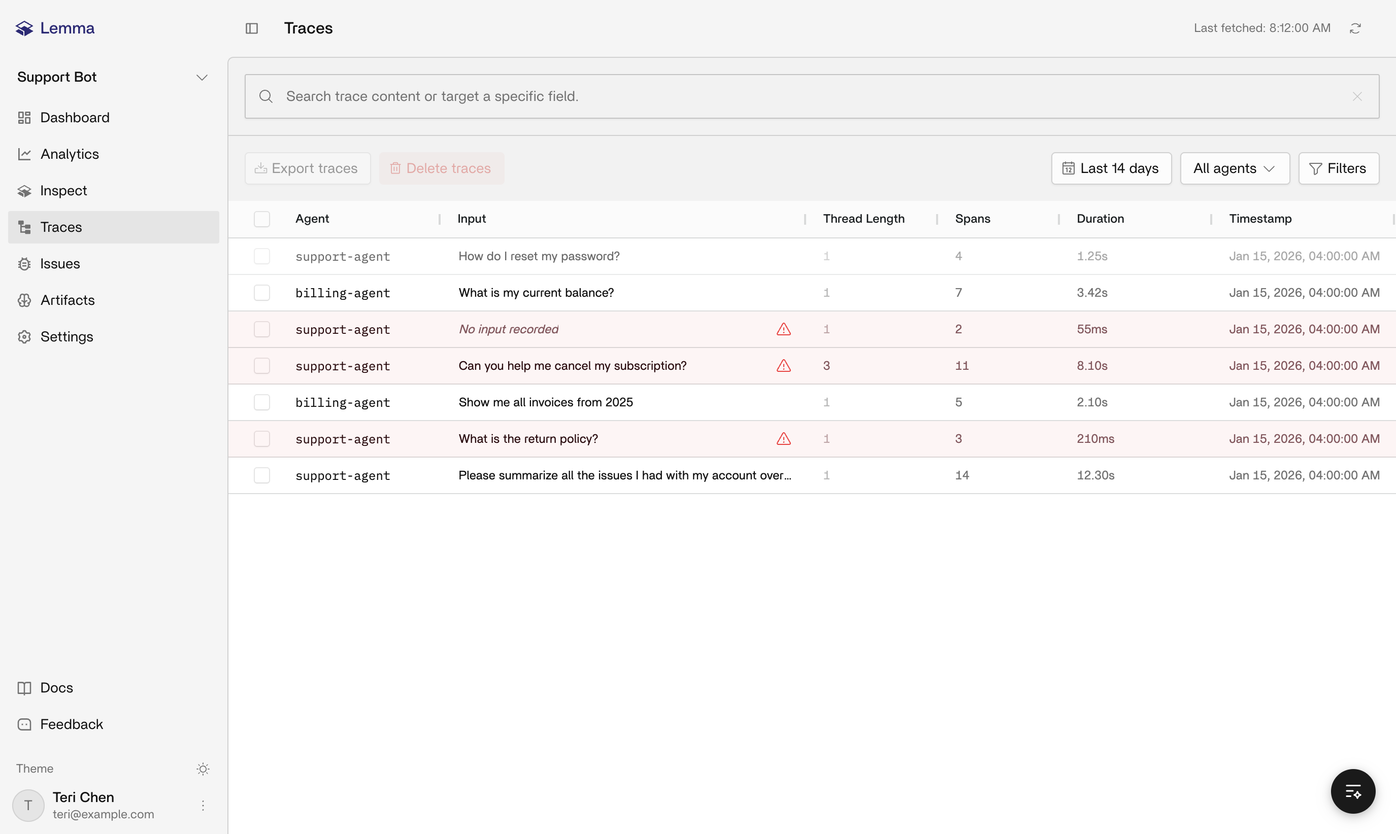 Traces table showing rows with input previews, span counts, durations, and error marks