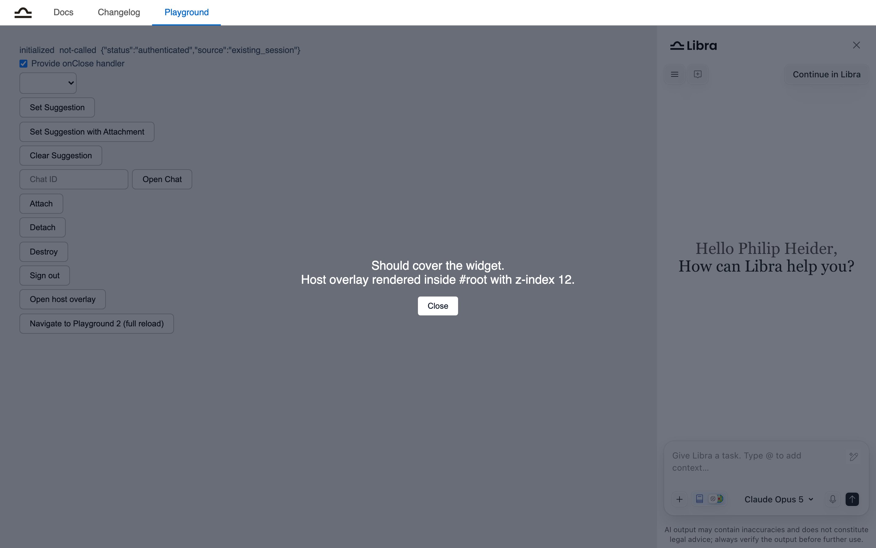 The playground with a dark host overlay covering both the page content and the Libra widget