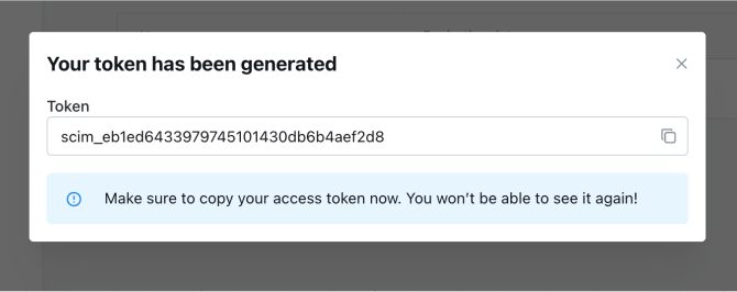 The generated SCIM token shown once in a modal, with a button to copy it