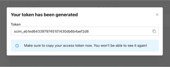 The generated SCIM token shown once in a modal, with a button to copy it