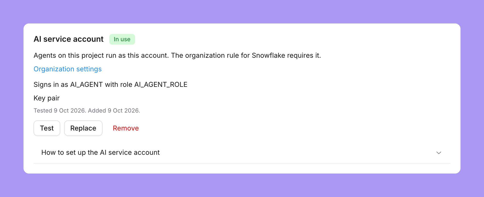The shared agent account card on a Snowflake project, marked In use: Agents on this project run as this account. The organization rule for Snowflake requires it, an Organization settings link, Signs in as AI_AGENT with role AI_AGENT_ROLE, Key pair, Tested 9 Oct 2026. Added 9 Oct 2026, and Test, Replace and Remove buttons