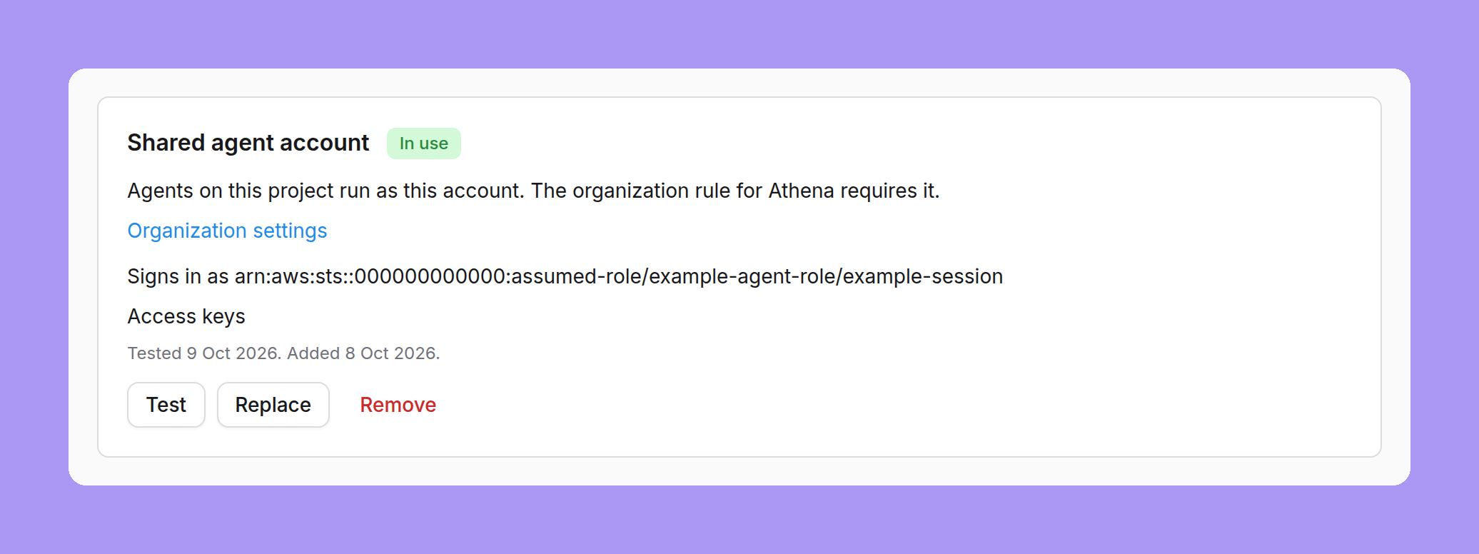 The shared agent account card on an Athena project, marked In use: Agents on this project run as this account. The organization rule for Athena requires it, an Organization settings link, Signs in as followed by an assumed-role ARN, Access keys, Tested 9 Oct 2026. Added 8 Oct 2026, and Test, Replace and Remove buttons