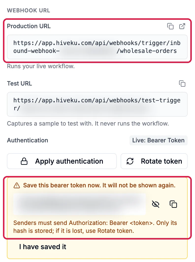 Webhook URL: the Production URL ending in wholesale-orders, outlined, the Test URL, Apply authentication and Rotate token, and the box Save this bearer token now. It will not be shown again, outlined. The address and token are blurred