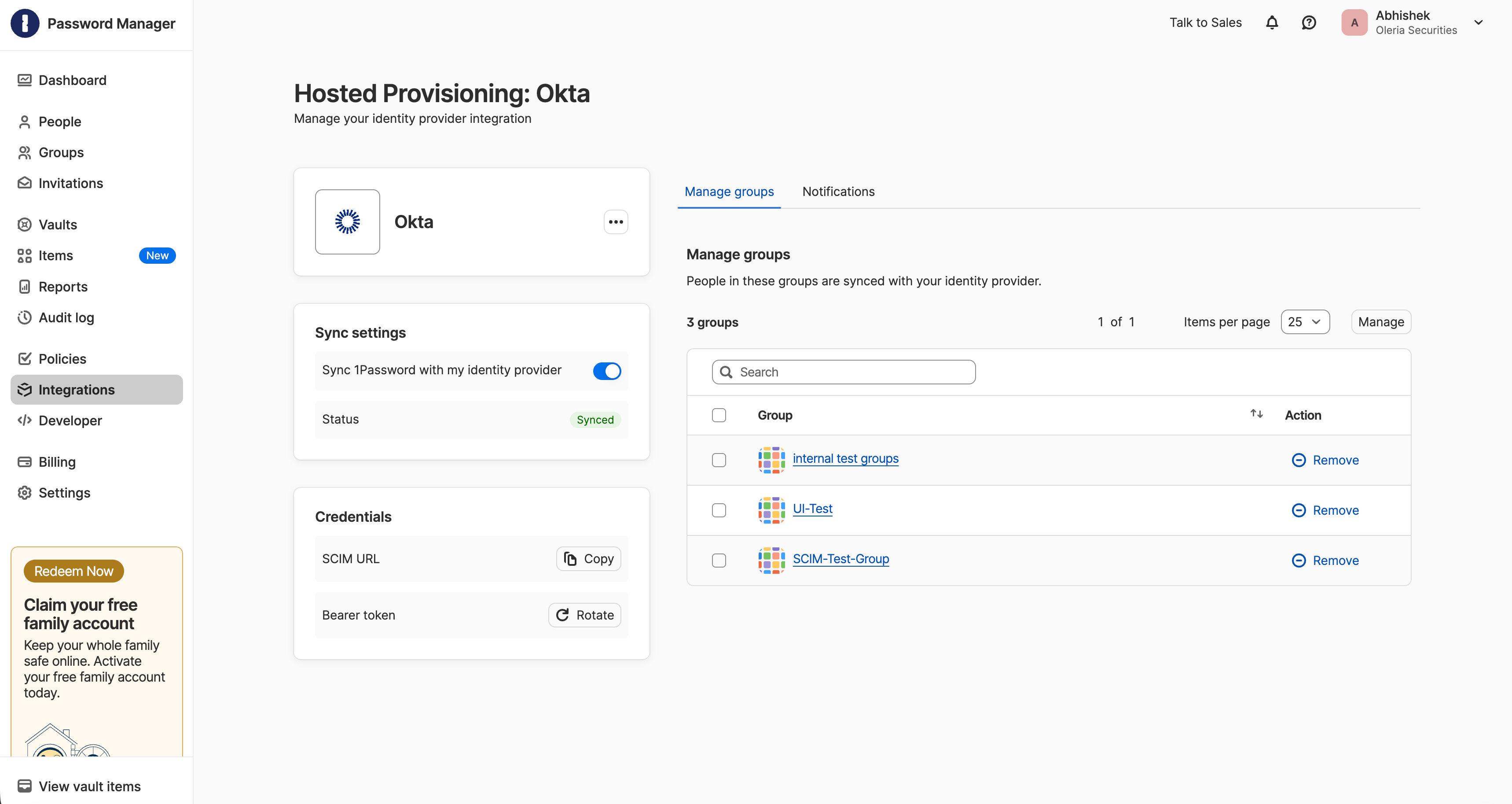 1Password Hosted Provisioning page for Okta, showing the SCIM URL and Bearer token under Credentials, and the Manage groups tab listing three groups