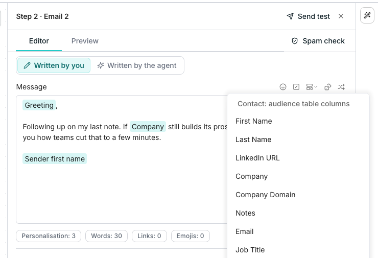 A follow-up email's Editor tab with Written by you selected. Its message holds three variable pills, Greeting, Company and Sender first name, around a typed follow-up line. The variables menu, open from the toolbar beside Message, lists the audience table's columns: First Name, Last Name, LinkedIn URL, Company, Company Domain, Notes, Email and Job Title.
