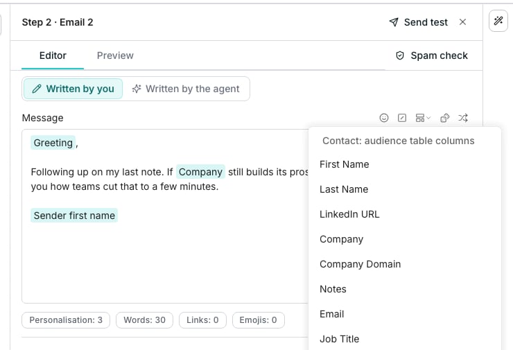 A follow-up email's Editor tab with Written by you selected. Its message holds three variable pills, Greeting, Company and Sender first name, around a typed follow-up line. The variables menu, open from the toolbar beside Message, lists the audience table's columns: First Name, Last Name, LinkedIn URL, Company, Company Domain, Notes, Email and Job Title.