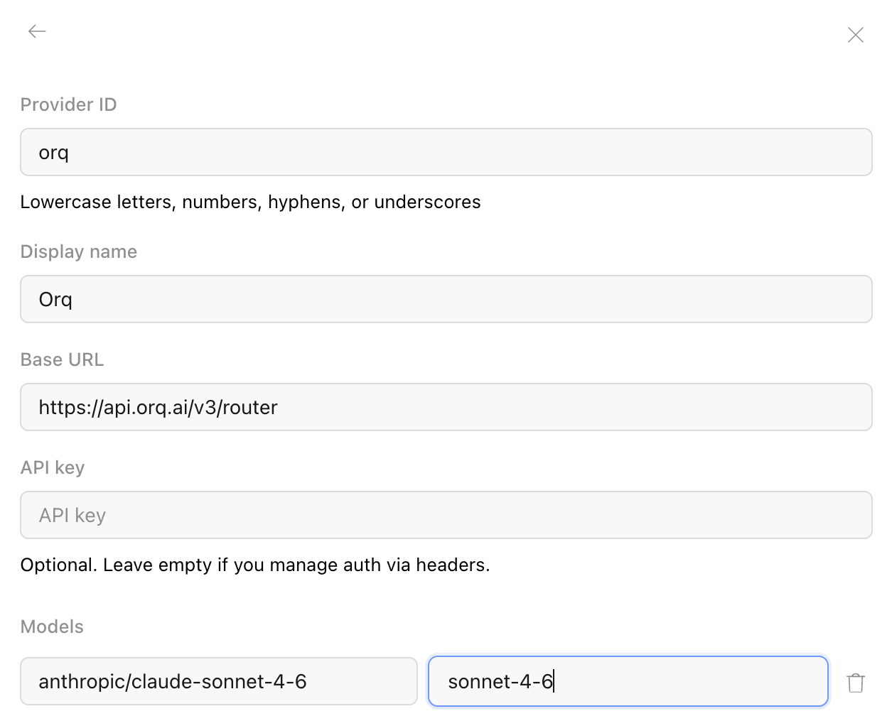 OpenCode Desktop custom provider form filled in with the Orq ID, Orq display name, router base URL, API key, and a model ID