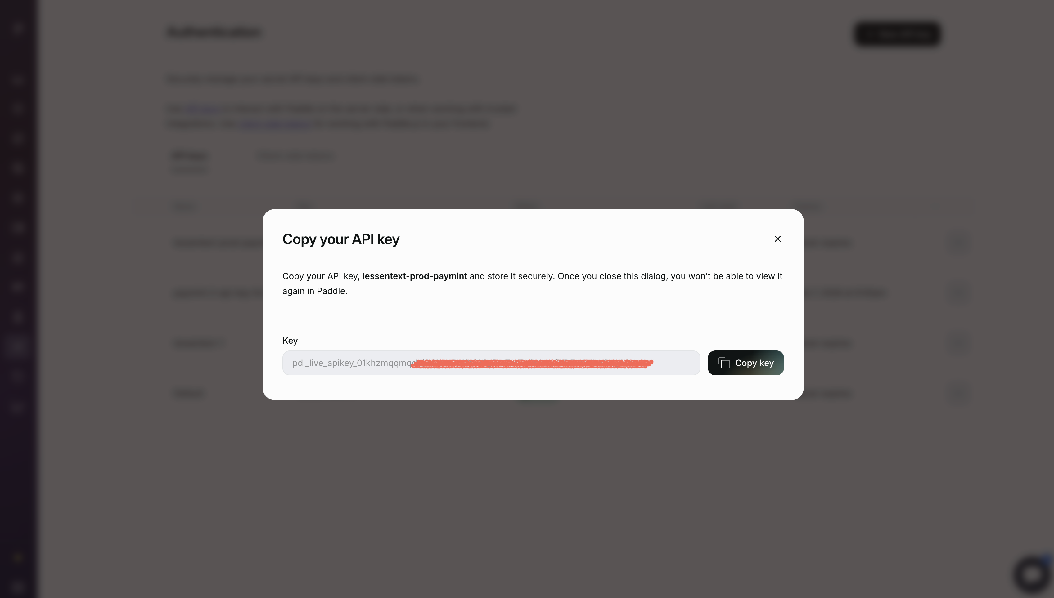 Paddle dialog showing the generated API key with a Copy key button