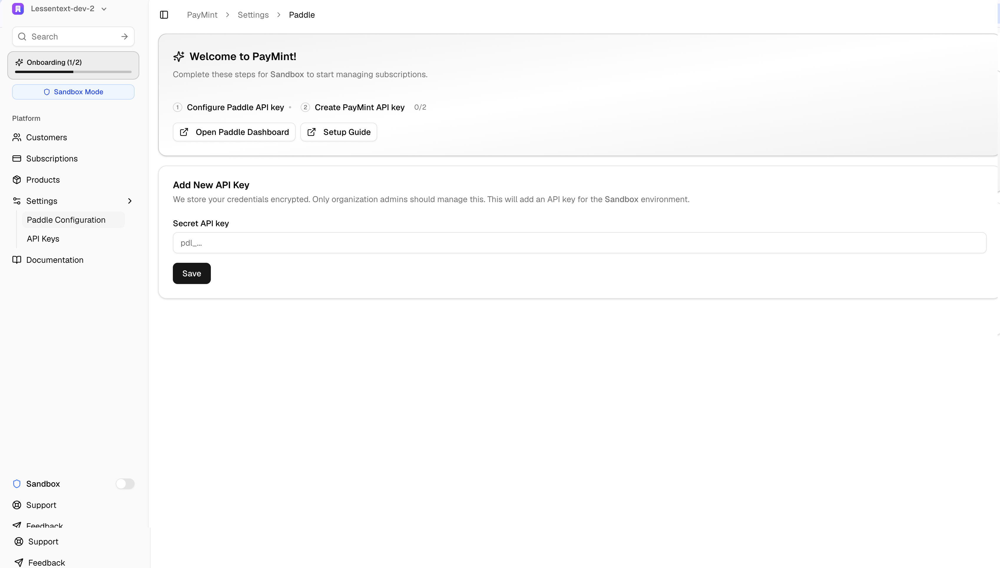 Paymint Paddle Configuration page showing the Secret API key input field and provisioning progress