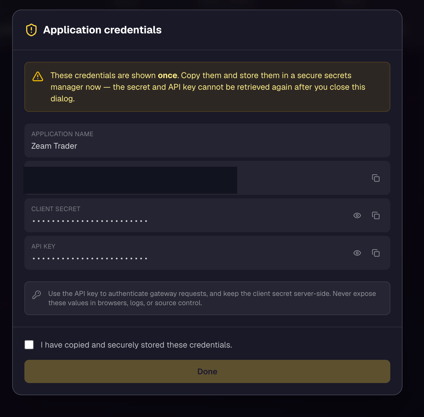 The Application credentials dialog for Zeam Trader, showing a one-time warning, the application name, a redacted client ID, a masked client secret, and a masked API key, with a confirmation checkbox and a Done button.