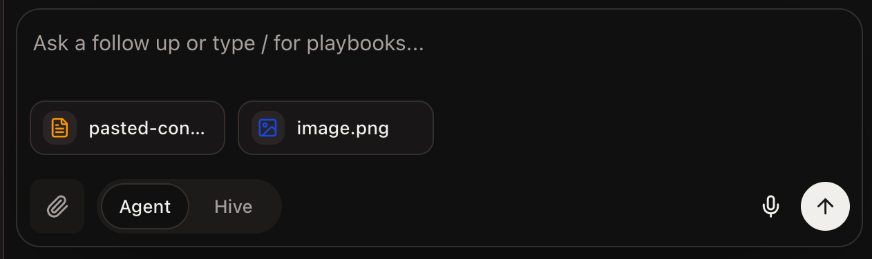 The prompt window with an image and a pasted-content file attached as chips before sending