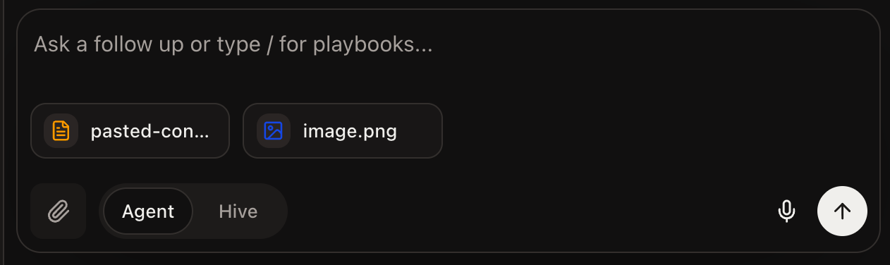 The prompt window with an image and a pasted-content file attached as chips before sending