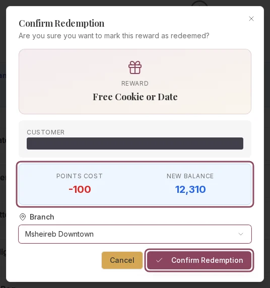The Confirm Redemption dialog showing the points cost, the new balance, and the branch selector