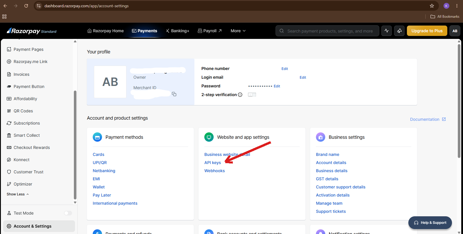 Razorpay Account Settings page with a red arrow pointing to the API keys link under Website and app settings