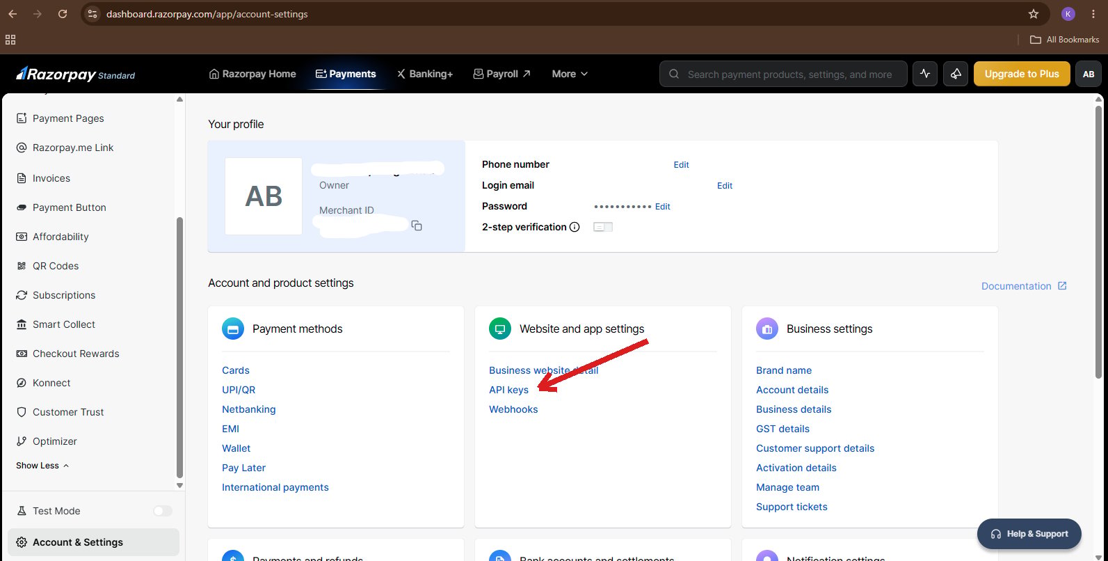 Razorpay Account Settings page with a red arrow pointing to the API keys link under Website and app settings