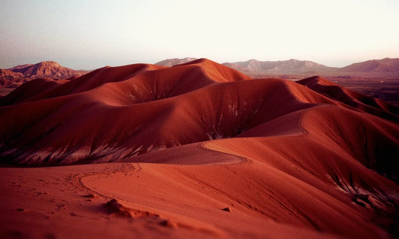 Rolling red sand dunes at dusk