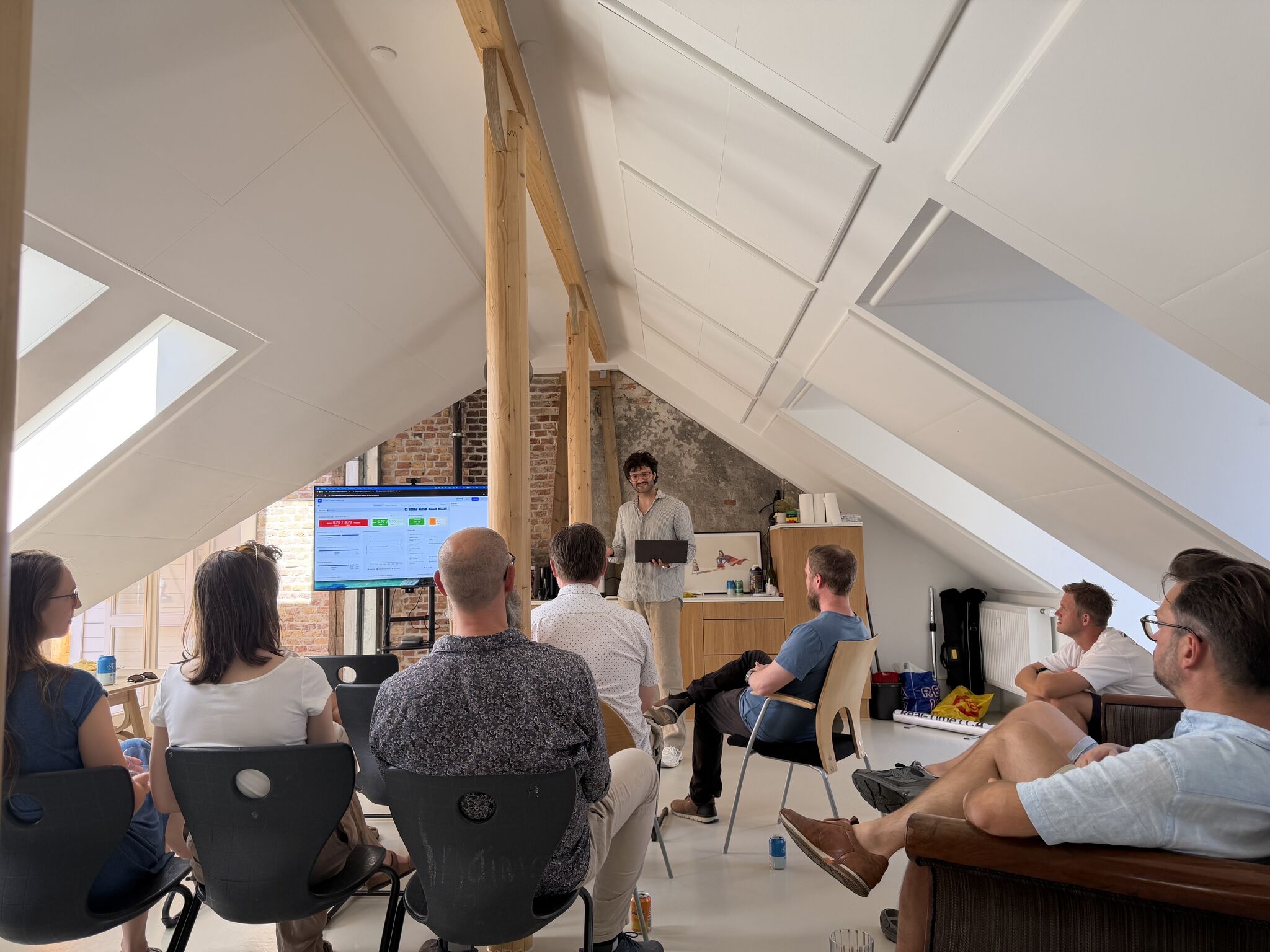 Presenter walking the community through new Real-Time LCA features in a sunlit attic room.