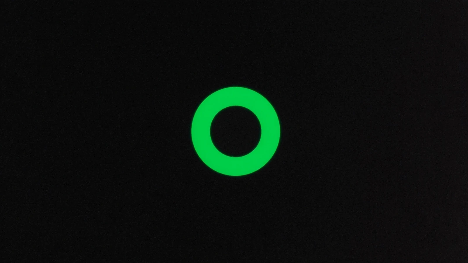 A thick continuous green ring on a black background