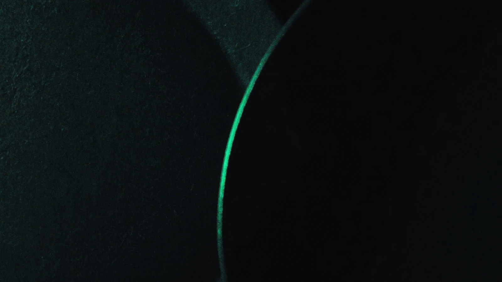 Two matte plates fitting together, the seam between them lit in green