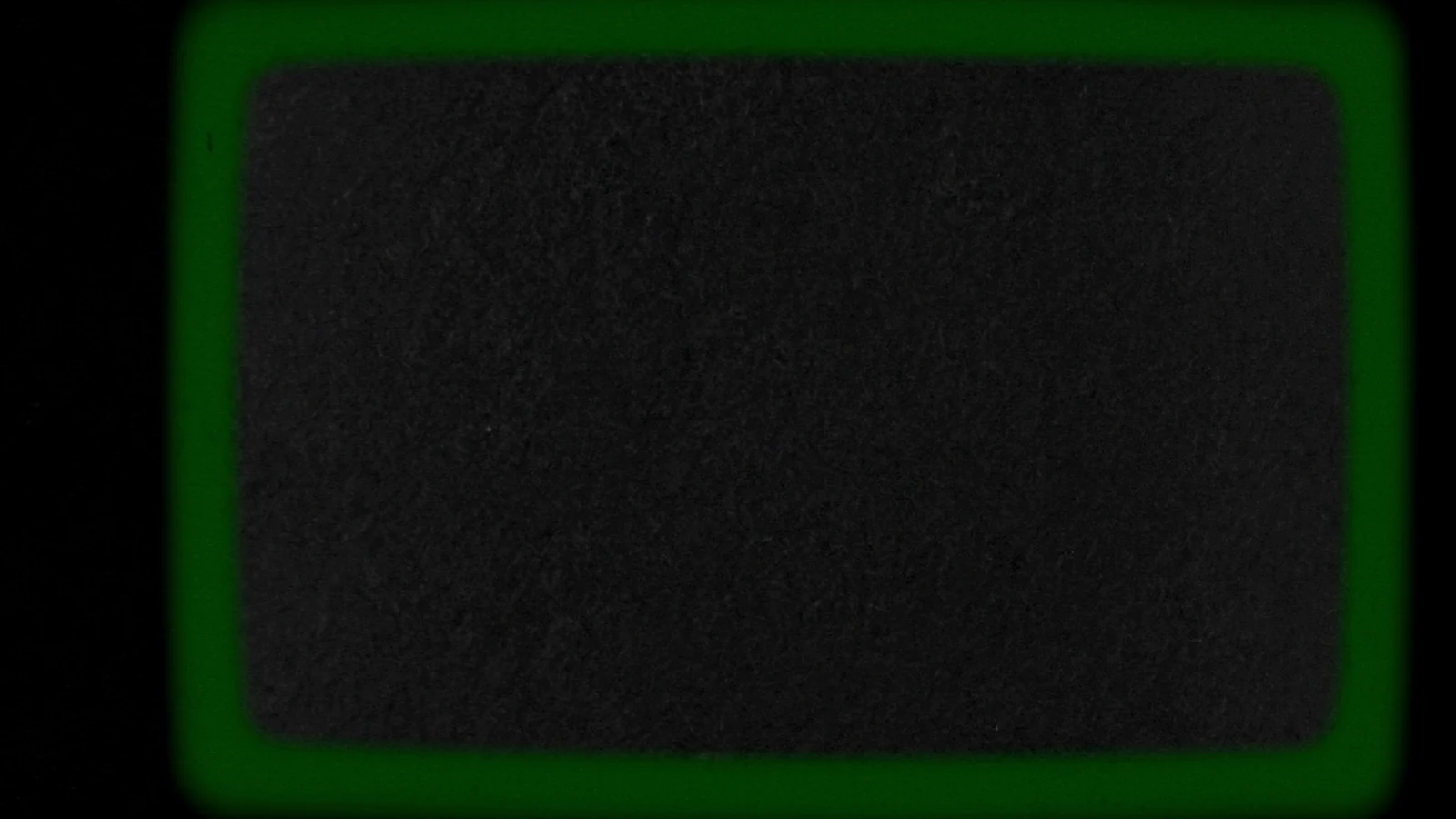 A large matt cube crossed by a single seam of green light