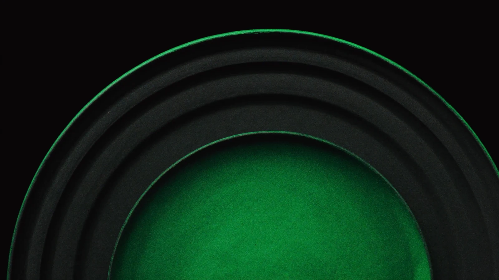 Concentric matt arcs above a dome of green light