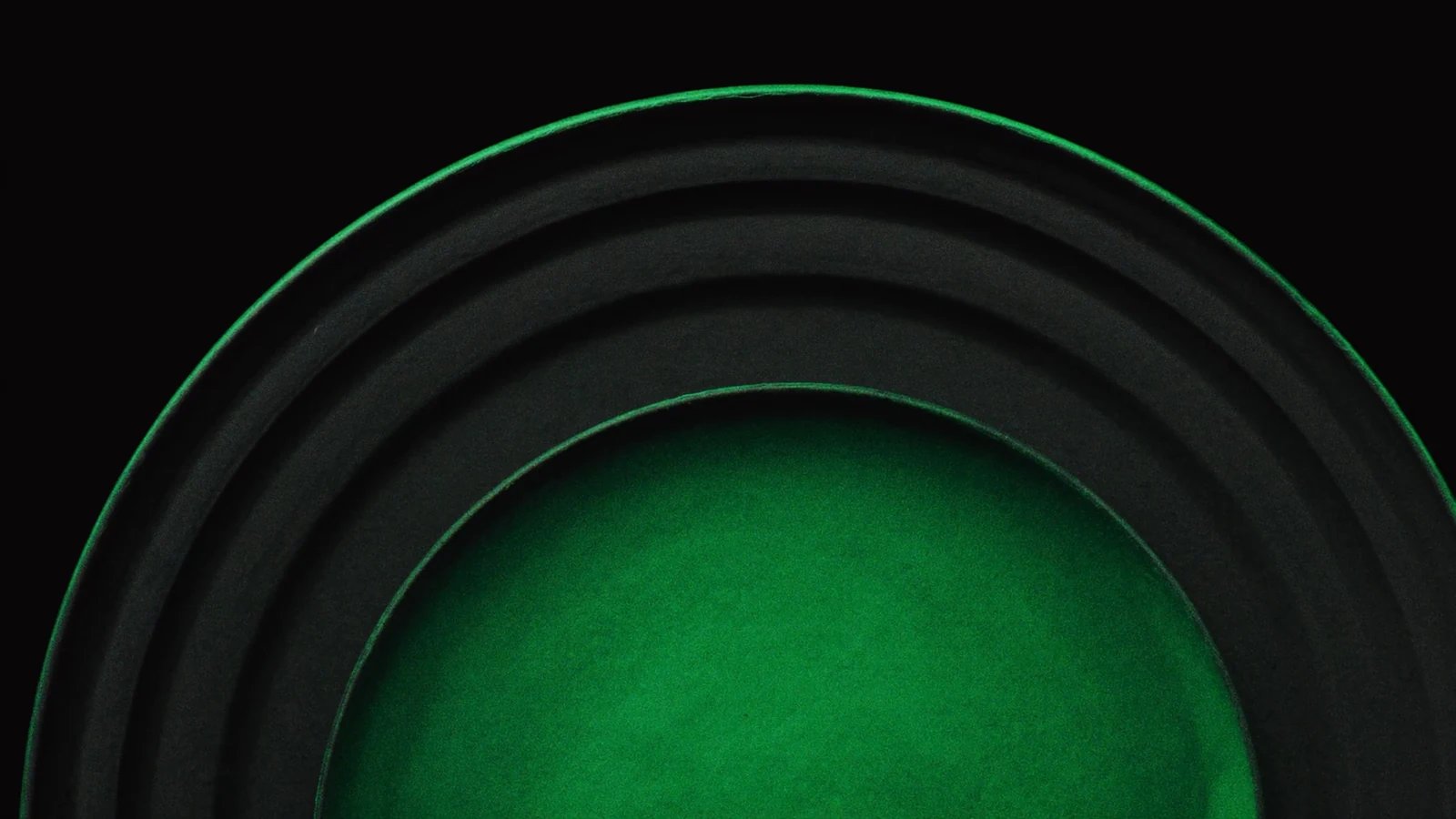 Concentric matt arcs above a dome of green light