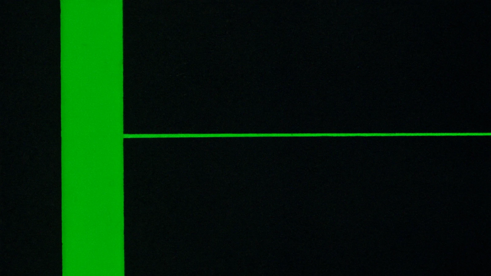 A matte plane divided by green light into unequal segments