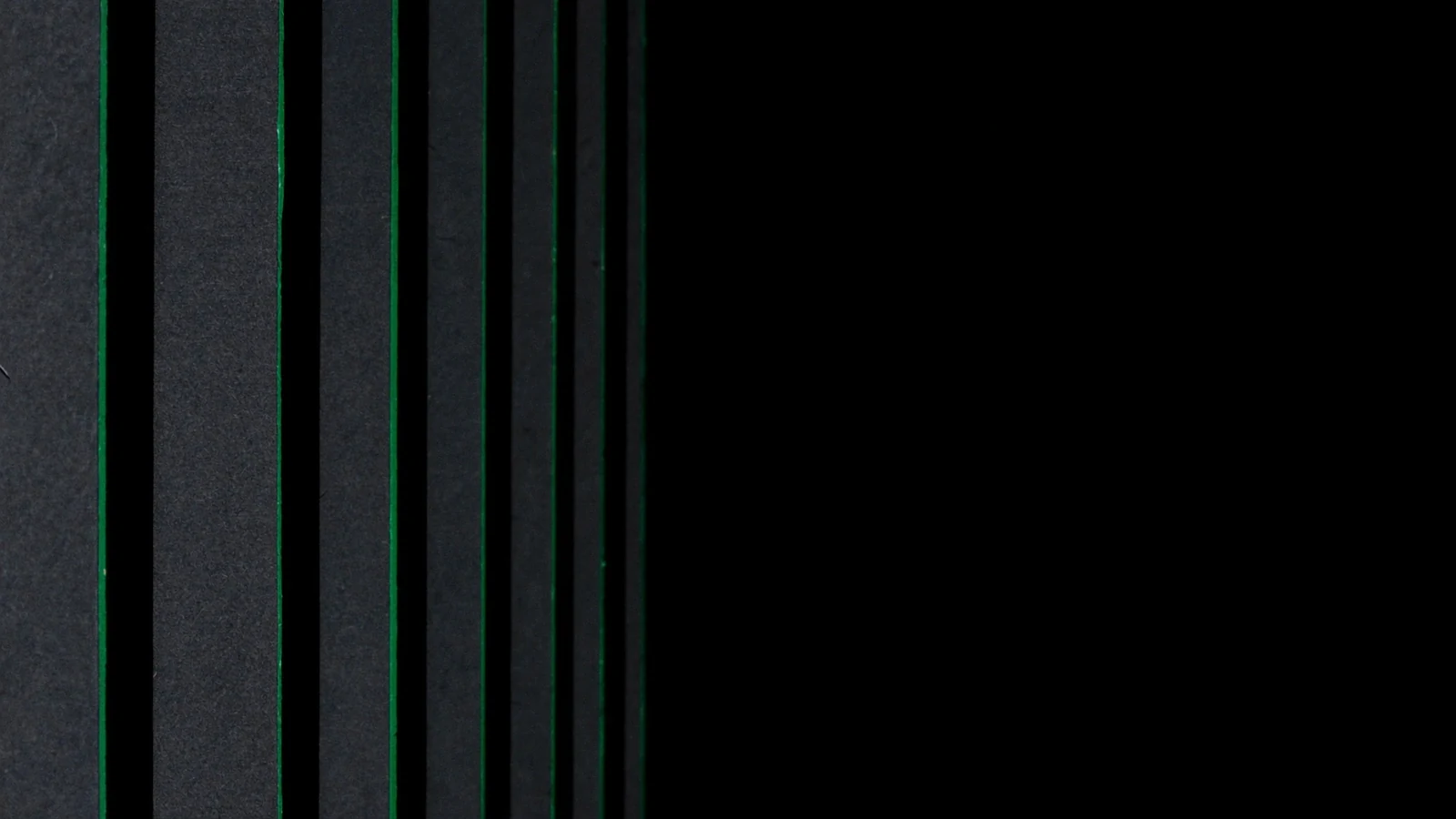 Rows of matte shelves receding into the dark, each edge lit in green