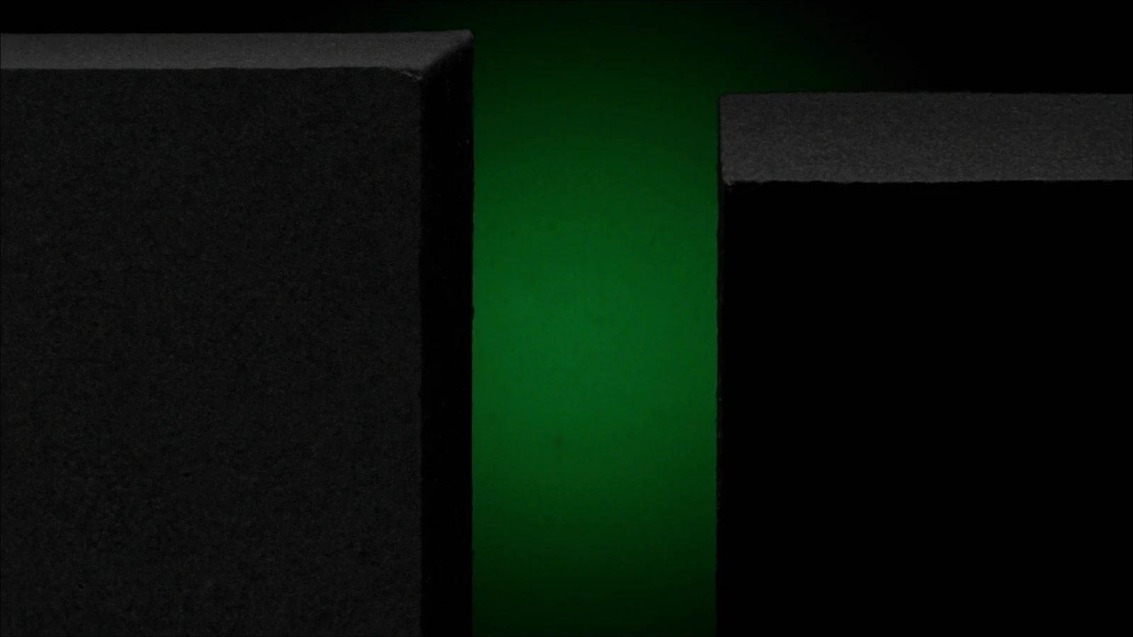 Two matte blocks of different heights with a green glow in the gap between them