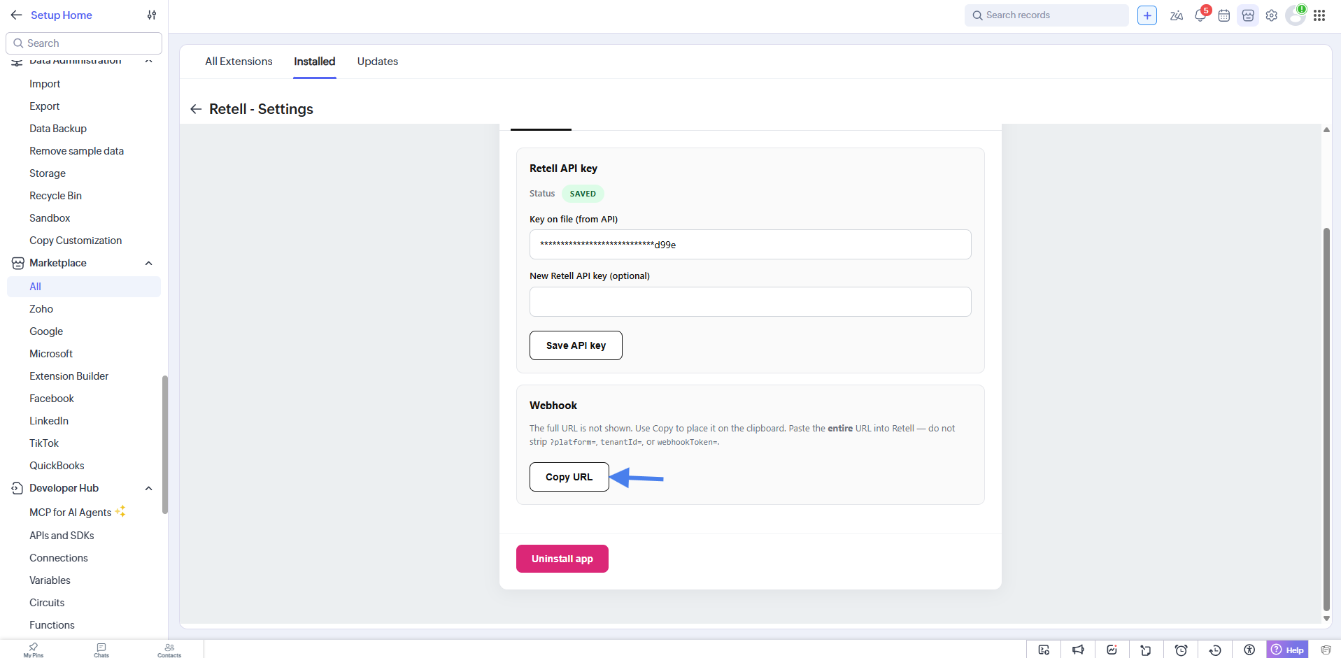 Retell Settings page in Zoho CRM showing the saved API key, the Webhook section with a Copy URL button, and the Uninstall app button