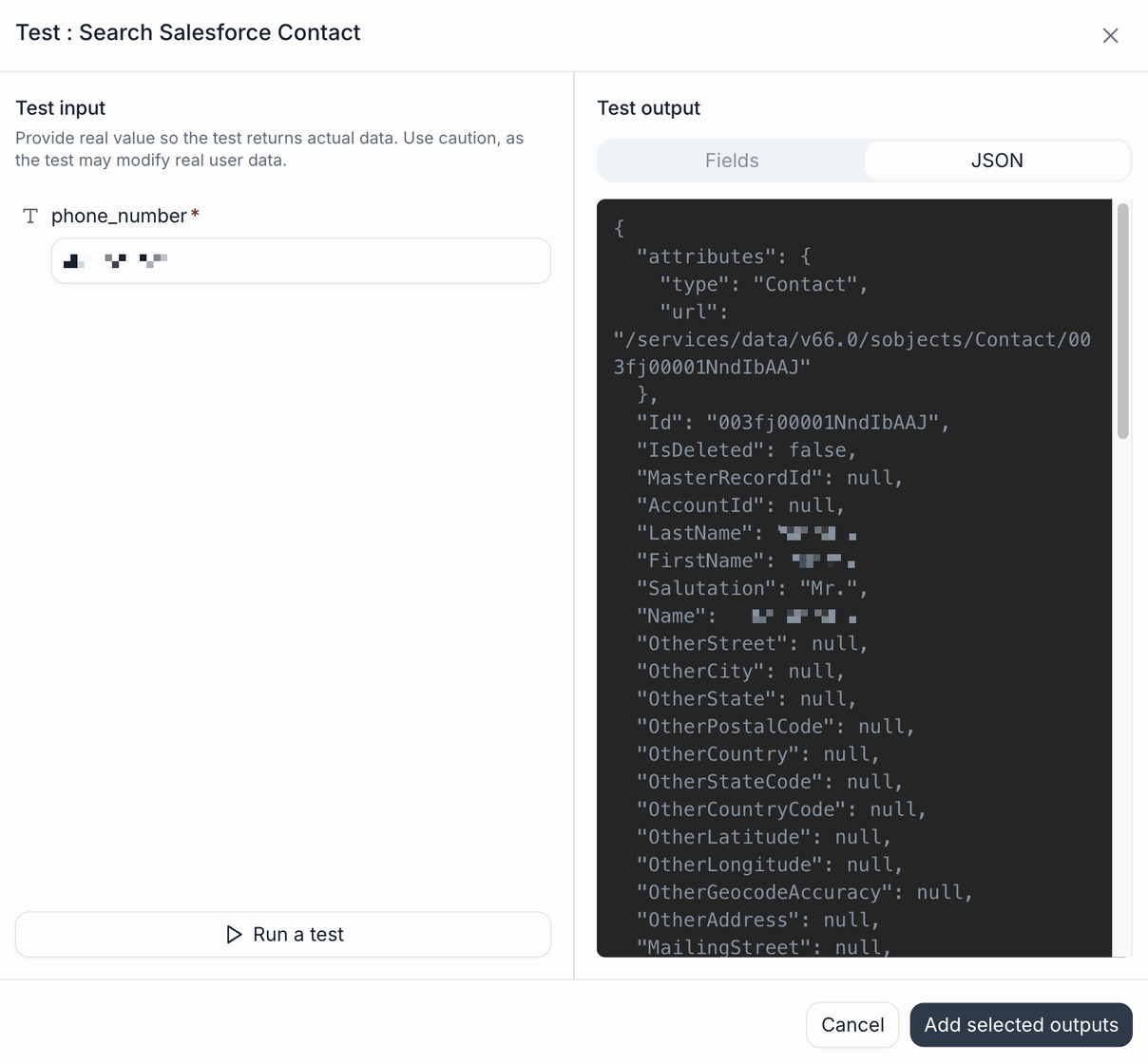 The Test : Search Salesforce Contact dialog. The left pane, Test input, warns to provide real values because the test may modify real user data, and holds a required phone_number field whose value is pixelated, above a Run a test button. The right pane, Test output, has Fields and JSON tabs with JSON selected, showing the live Salesforce response: an attributes object with type Contact and a record url, then Id, IsDeleted false, MasterRecordId, AccountId, and a long list of fields, with the LastName, FirstName, and Name values pixelated and the remaining address fields null. Cancel and Add selected outputs buttons sit at the bottom.