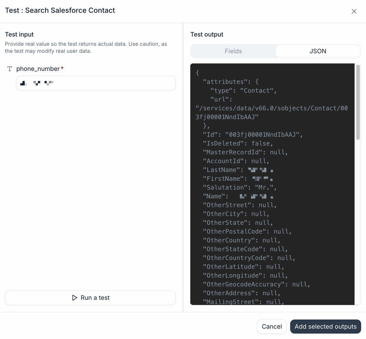 The Test : Search Salesforce Contact dialog. The left pane, Test input, warns to provide real values because the test may modify real user data, and holds a required phone_number field whose value is pixelated, above a Run a test button. The right pane, Test output, has Fields and JSON tabs with JSON selected, showing the live Salesforce response: an attributes object with type Contact and a record url, then Id, IsDeleted false, MasterRecordId, AccountId, and a long list of fields, with the LastName, FirstName, and Name values pixelated and the remaining address fields null. Cancel and Add selected outputs buttons sit at the bottom.