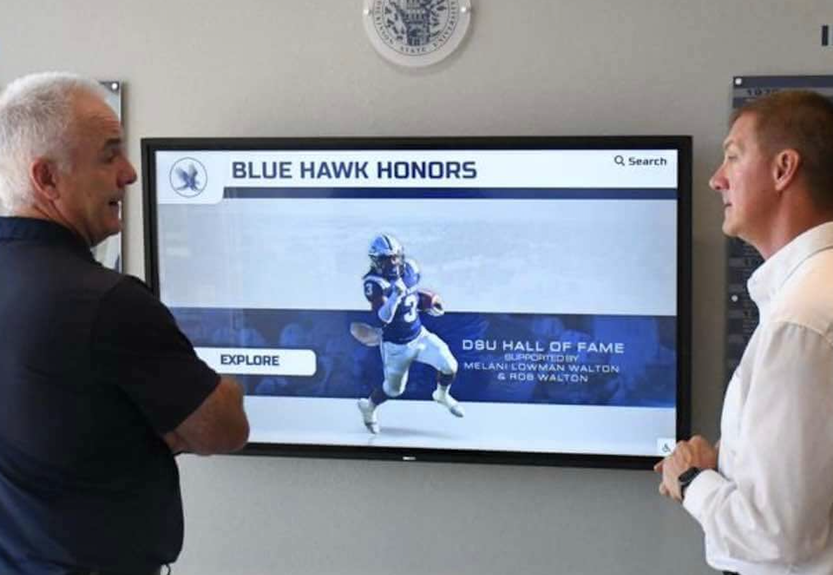 Wall-mounted touchscreen showing a full-screen Rocket hall of fame site with no browser address bar or controls